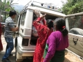 Receiving relief materials from LEADERS Nepal’s vehicle.jpg